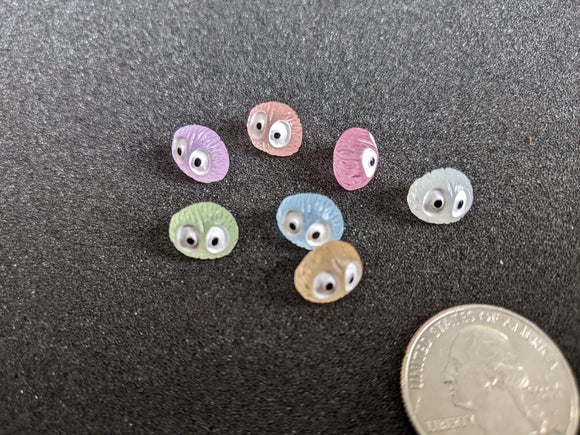 Tiny glow in the dark monsters with big eyes