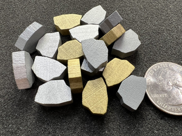 Nuggets of stone, silver and gold.  Board game resource tokens.